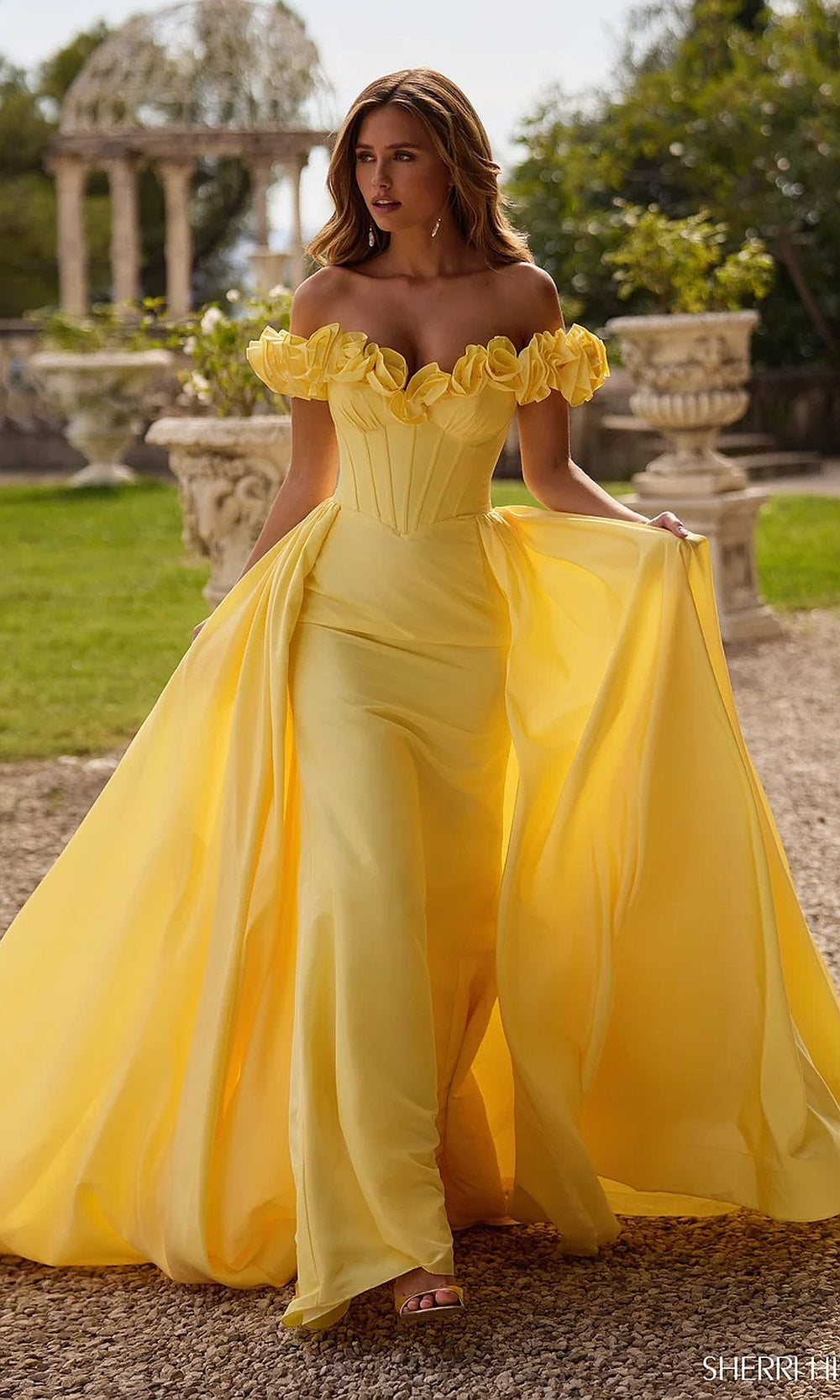 Sherri Hill 57200 Yellow prom gown full-length view with detachable ballgown overskirt, fitted corset underdress, chiffon organza train, red carpet styling