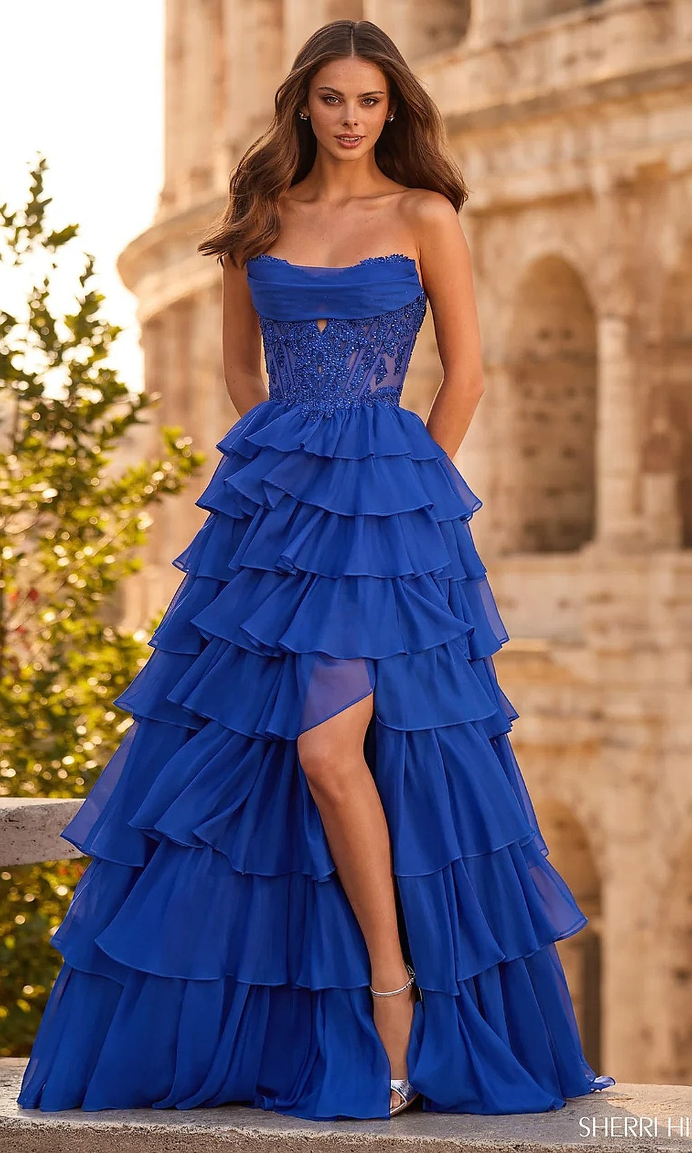Sherri Hill 57497 Royal prom ballgown front view with illusion beaded corset bodice, tiered chiffon ruffles, front slit, and strapless scoop neckline, formal prom gown
