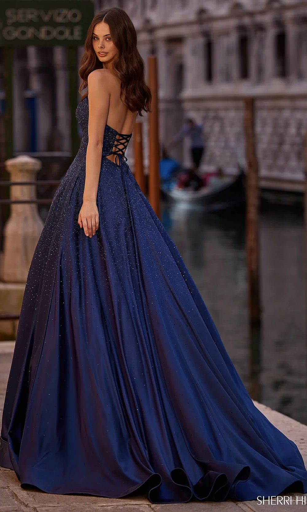 Sherri Hill 57552 Navy prom ballgown with lace-up corset back, hot-stone coverage, open back exposure, and sweep train, back view, evening gown