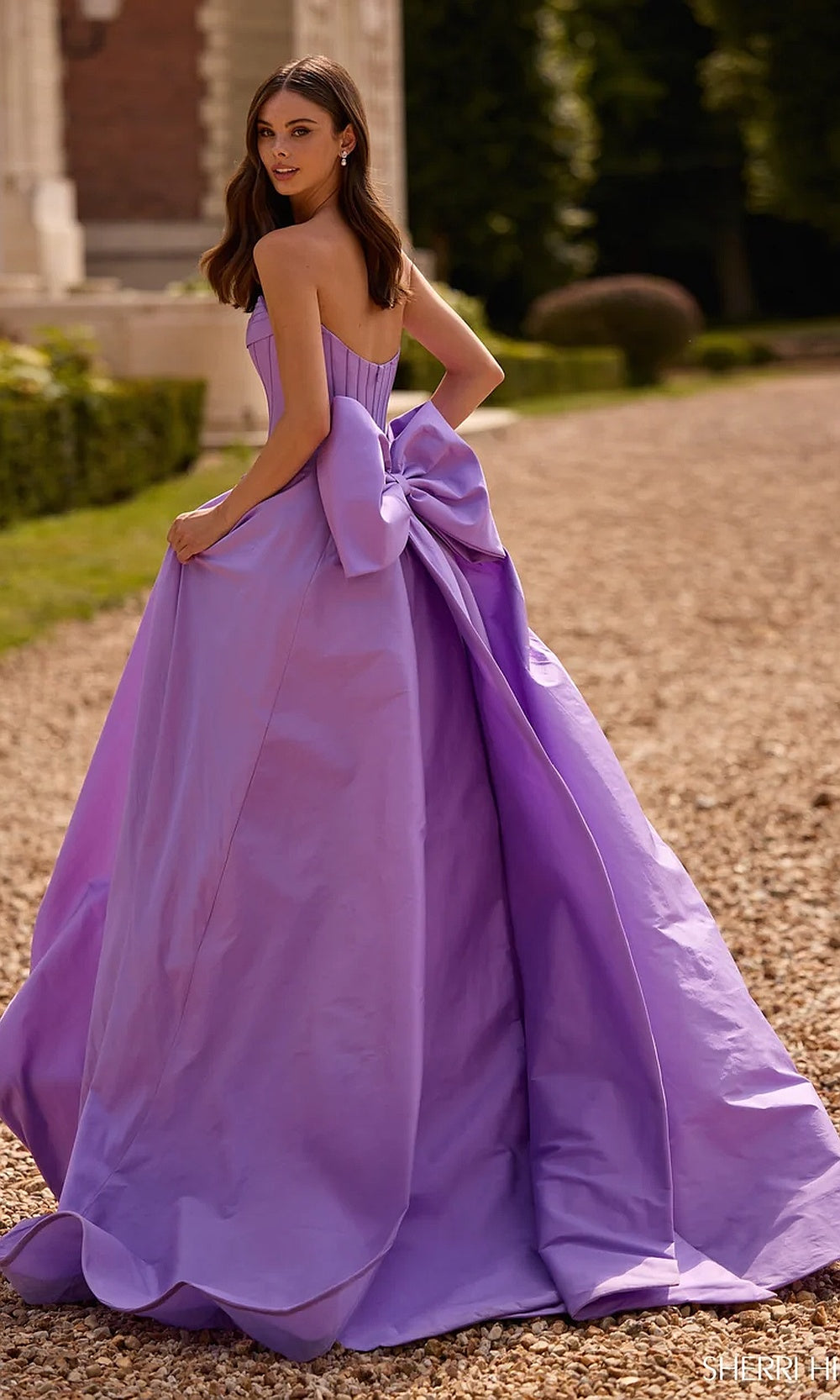 Sherri Hill 57629 Lilac prom back view strapless ballgown with oversized fabric bow at back waist and long train evening gown
