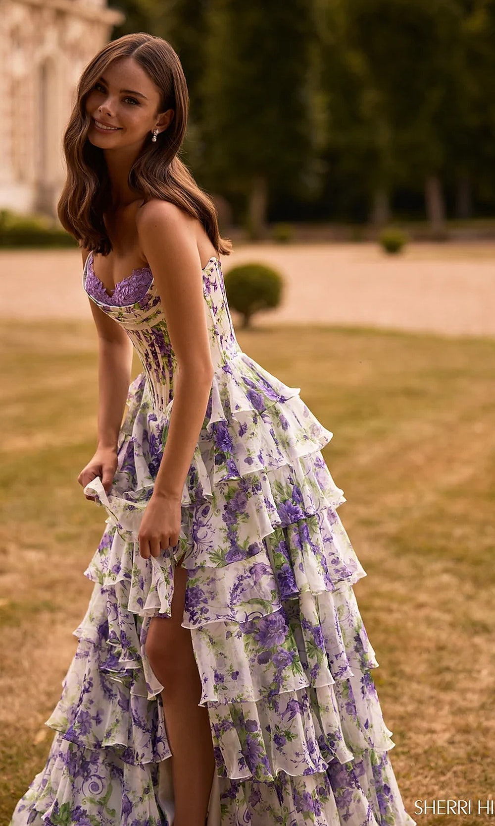 Sherri Hill 57692 Ivory Purple Green Print prom dress side view with floral chiffon tiered ruffle skirt high slit sweep train strapless sweetheart ballgown red carpet styling