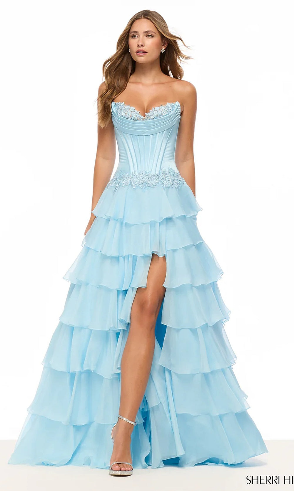Sherri Hill 57868 Light Blue prom ballgown front view with tiered ruffled chiffon skirt, sweetheart neckline, floral appliqués at waist, formal prom gown