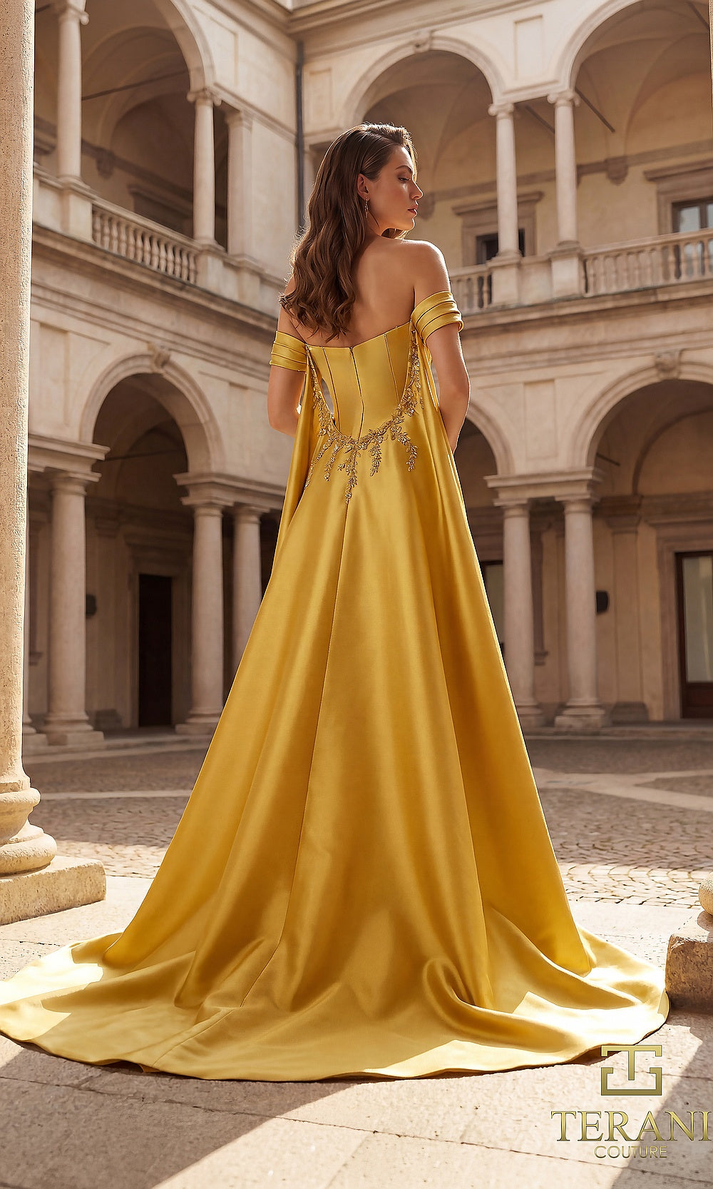 Terani Couture 262M7252 Gold mother of the bride dress back view with off-shoulder satin gown, beaded appliqué, flowing cape train, formal wedding celebration dress