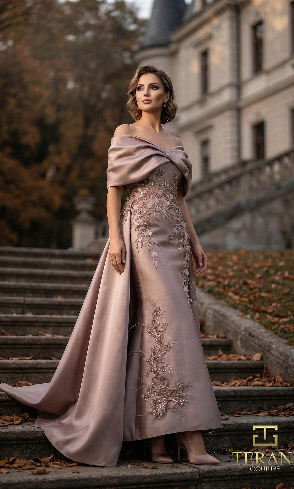 Terani Couture 262M7271 Mink mother of the bride dress front view with off-shoulder draped neckline, beaded embroidered satin column with sweeping overskirt, mother of the bride styling
