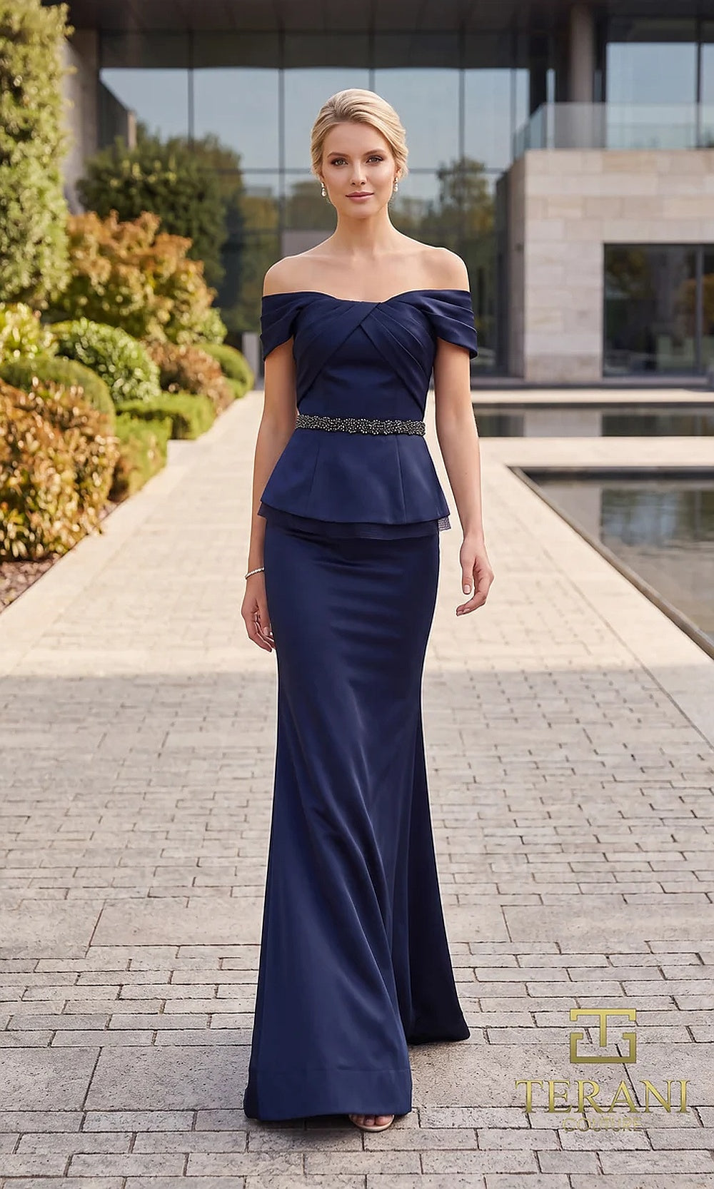 Terani Couture 262M7279 Navy mother of the bride dress front view with off-shoulder pleated neckline, beaded belt, crepe peplum mermaid, mother of the bride styling