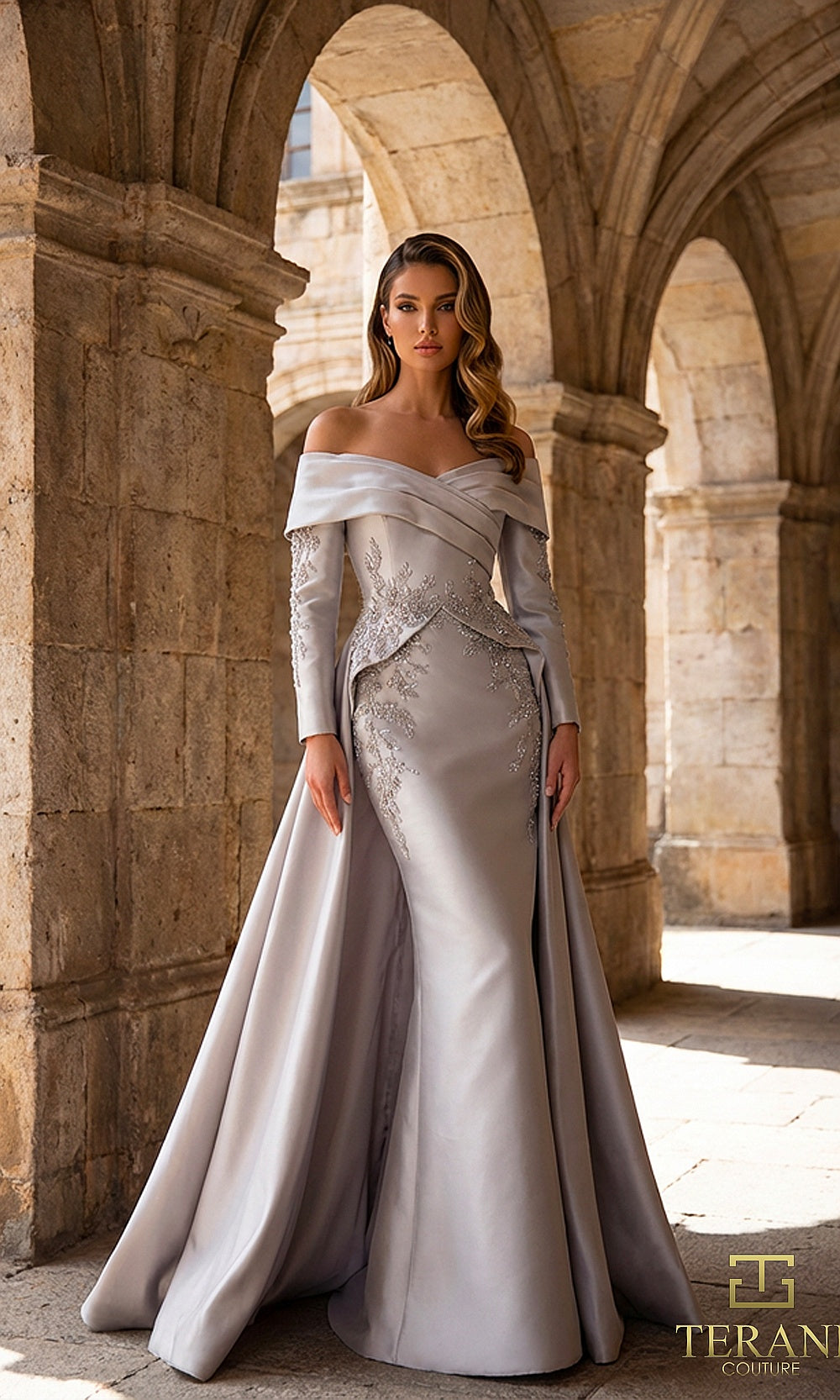 Terani Couture 262M7315 Silver Taupe mother of the bride dress front view with off-shoulder folded portrait collar, long-sleeve beaded appliqué bodice, satin column with overskirt, mother of the bride styling