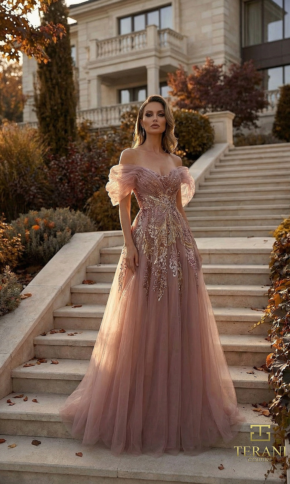 Terani Couture 262M7322 Rose Blush mother of the bride dress front view with off-shoulder ruched tulle sleeves, sequin floral embroidered bodice, tulle A-line ballgown, mother of the bride styling