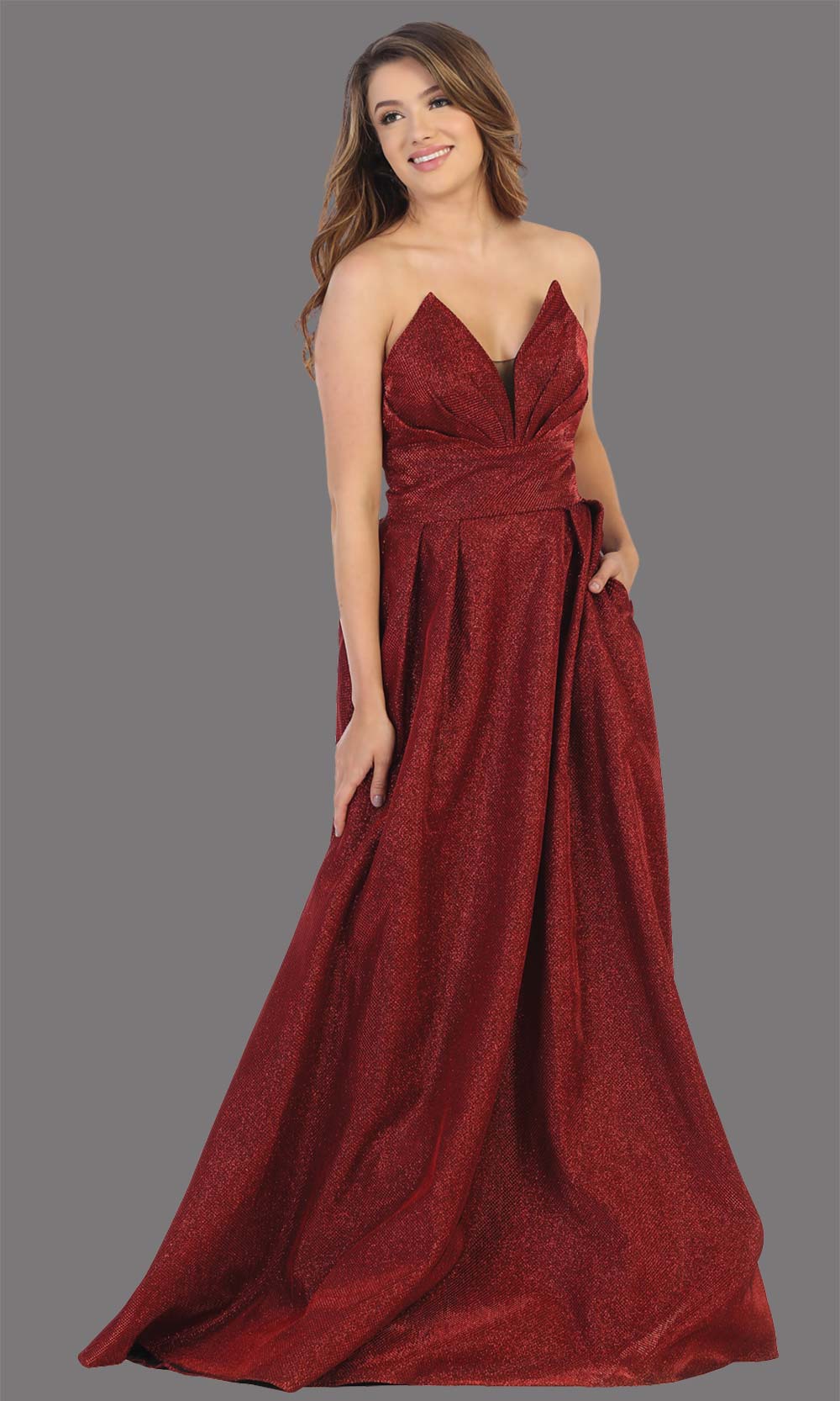 Mayqueen MQ1710 long burgundy metallic strapless flowy dress with pockets.This dark red a-line semi ballgown is perfect for prom, engagement dress, wedding reception dress, quinceanera, debut, sweet 16, formal wedding guest. Plus sizes are available